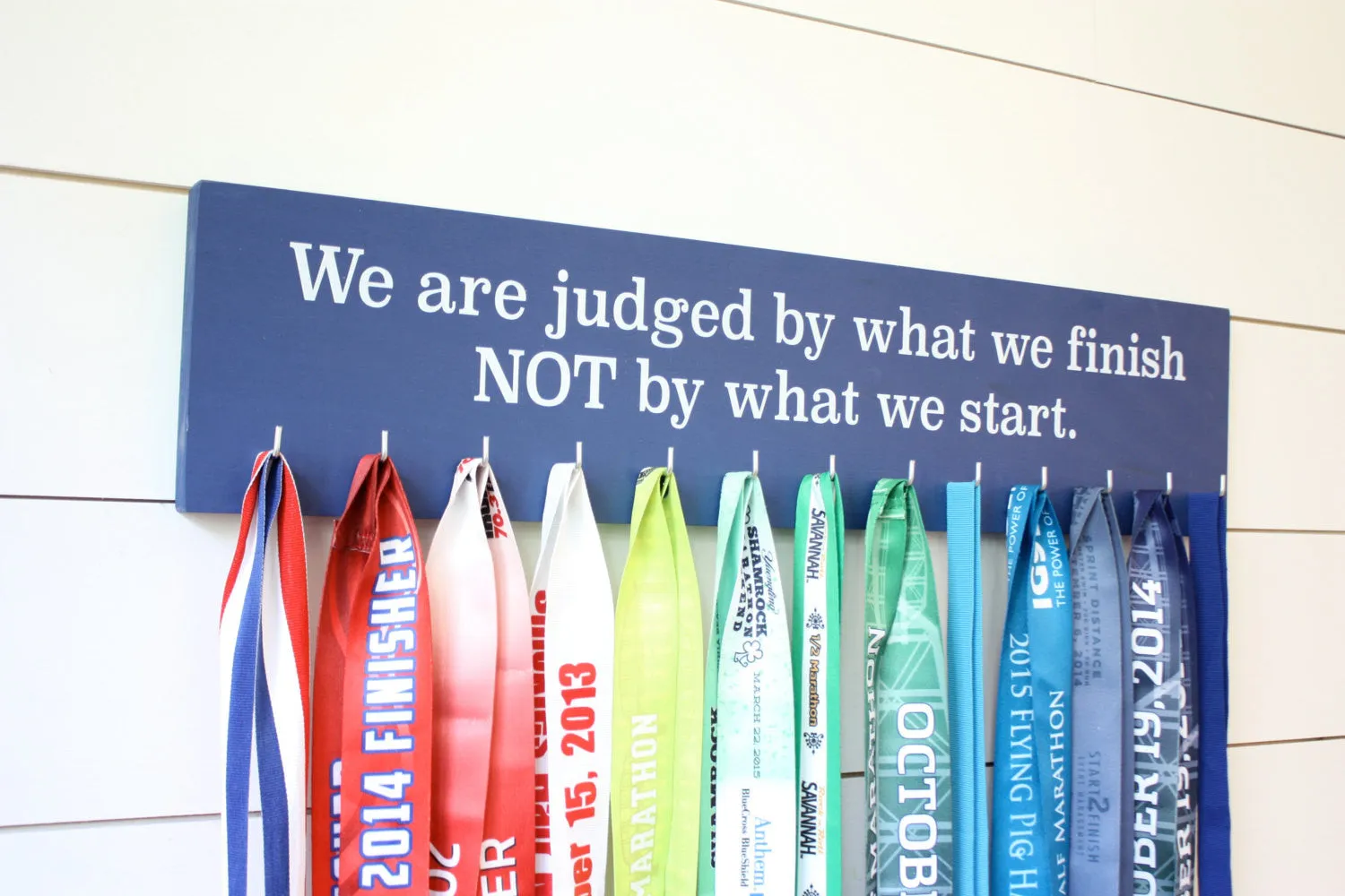 Medal Display - We are judged by what we finish NOT by what we start. - Large - Running / Triathlon / Ultra / Obstacle Race
