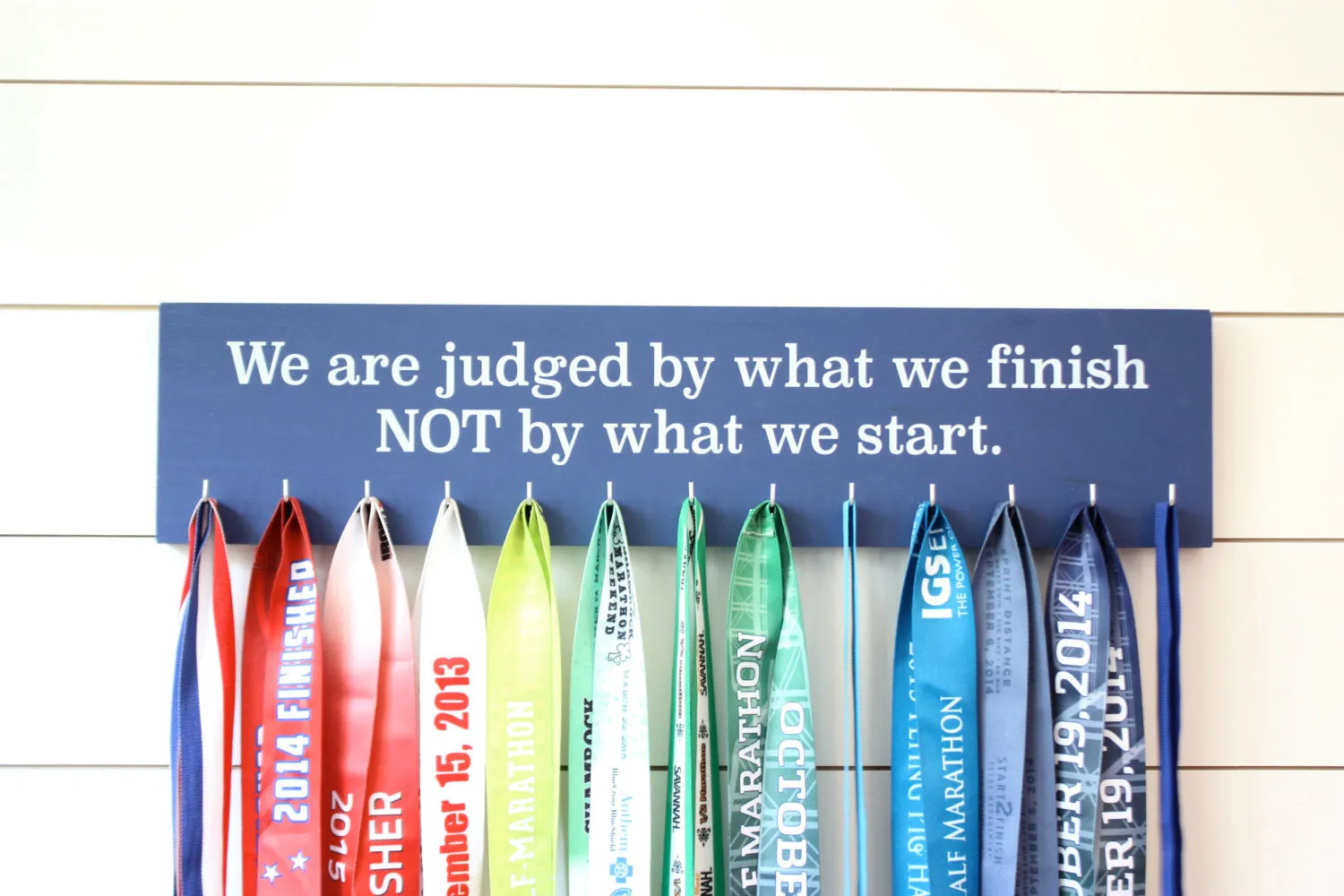Medal Display - We are judged by what we finish NOT by what we start. - Large - Running / Triathlon / Ultra / Obstacle Race